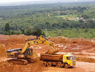 The land for this bauxite quarry in Sierra Leone belonged to the people of Mbonge village, but was sold to a mining company for a one-off payment. Photo: Jay Butcher/Tearfund