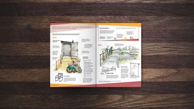 Las páginas centrales de una revista, abiertas en el centro de una mesa de madera, con información sobre el acceso a saneamiento, baños y agua potable