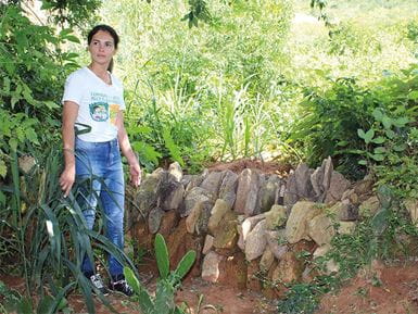 Maria has built stone banks to hold back rainwater and encourage it to soak into the soil, creating an area where she can grow many different types of trees and crops. Photo: Acervo Diaconia
