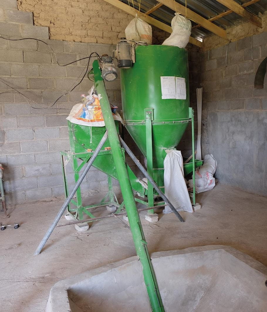 Residents of a rehabilitation centre use this mill to prepare feed for their hens. They are also able to sell bags of chicken feed in the village, helping them to make a profit. Photo: Alice Philip/Tearfund