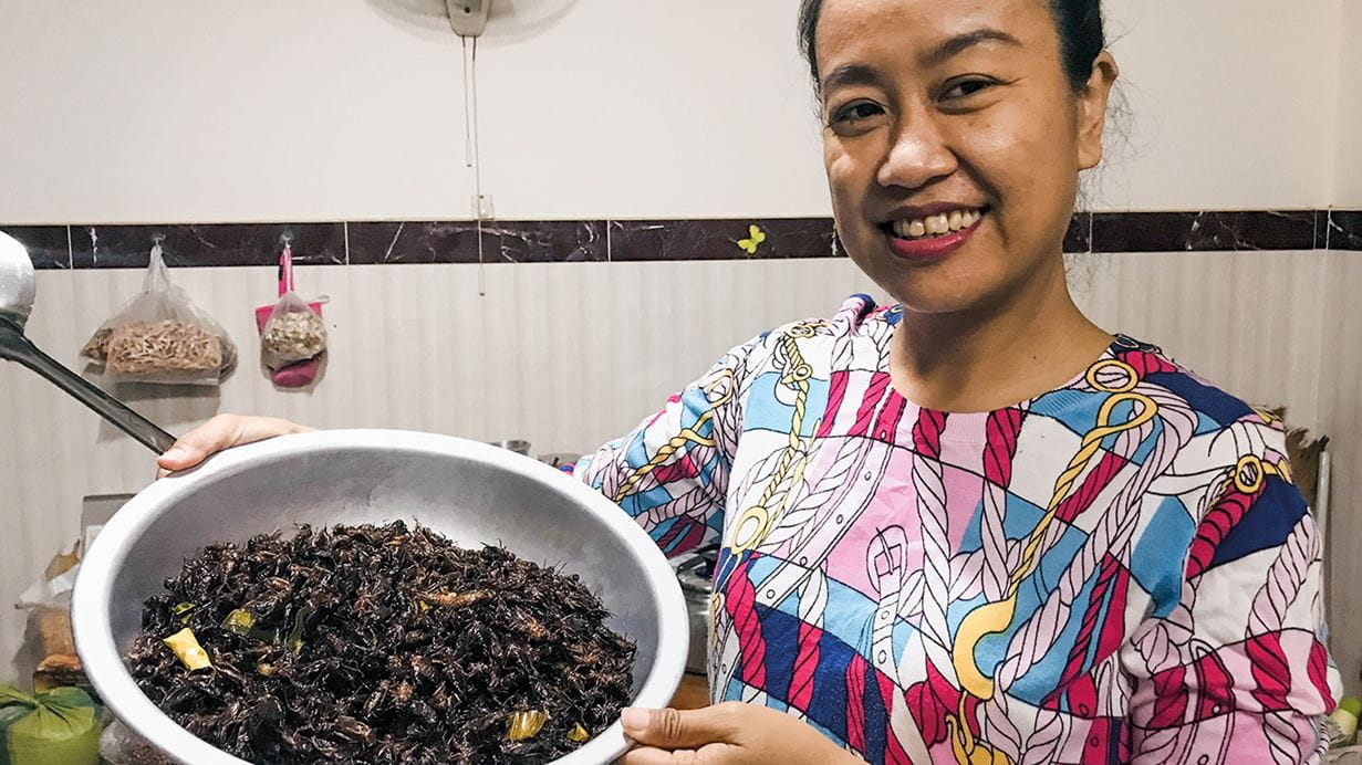 Chan Tola cooks the crickets according to the different tastes of her customers.