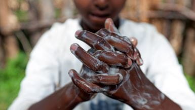 A close-up view of an Ethiopian man washing his hands