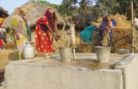 Woman pumping water in India