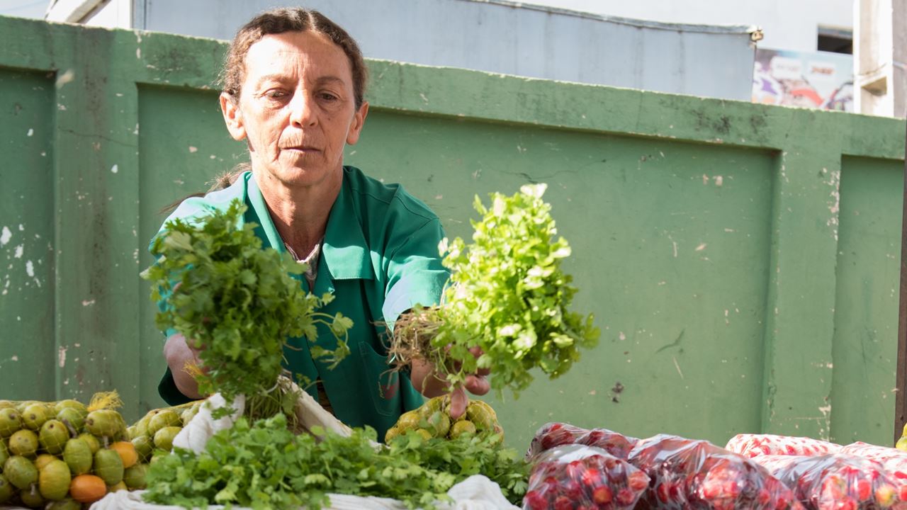 A farmer in Brazil sells her produce at market