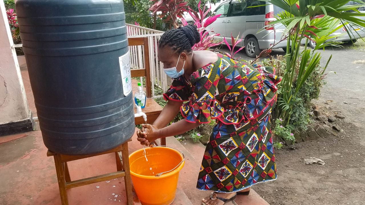 A woman washing her hands at an event where faith leaders attend Covid-19 response training
